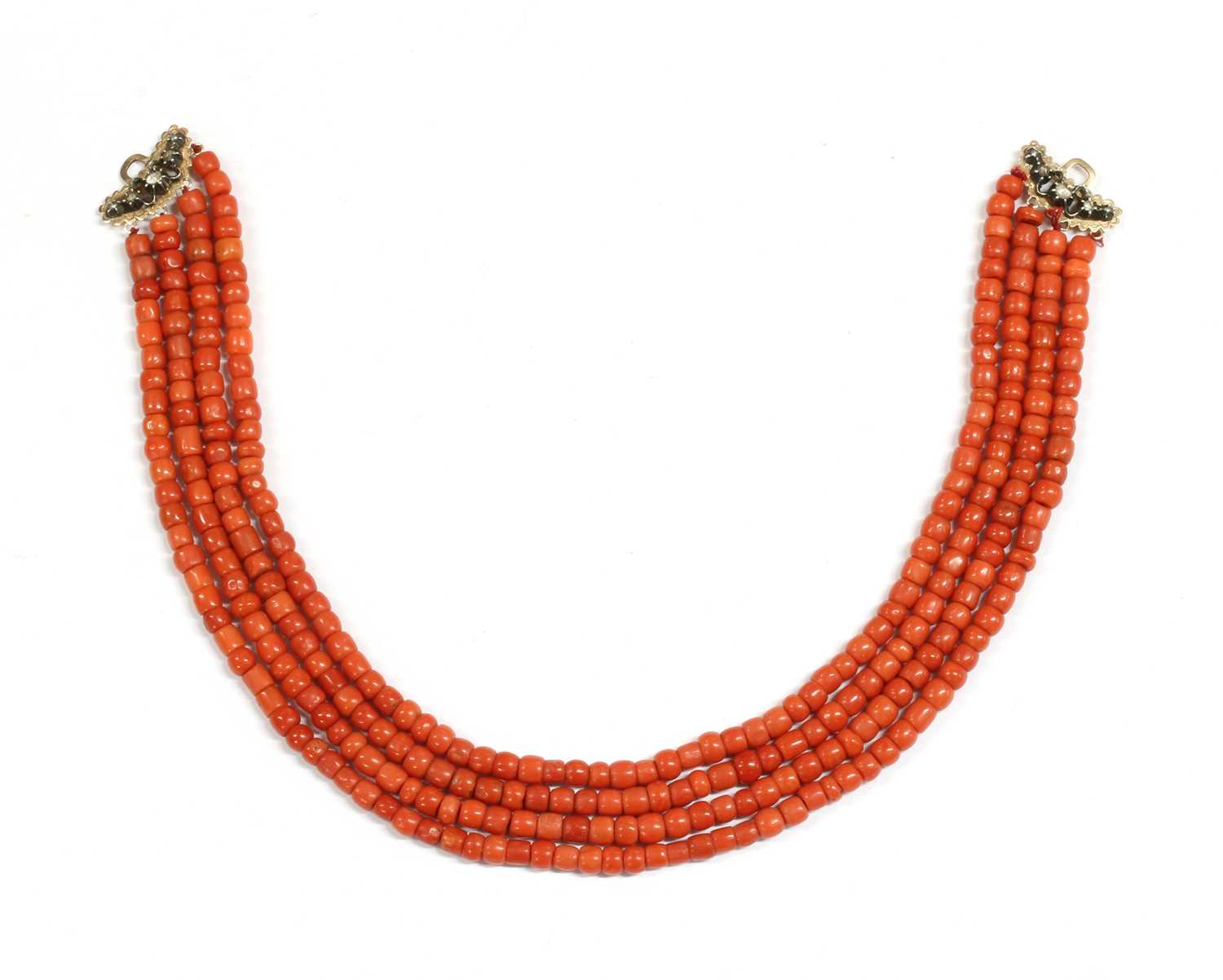 Lot 26 - A four row coral bead necklace