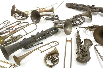 Lot 214 - A collection of French horns, saxophones and trombones