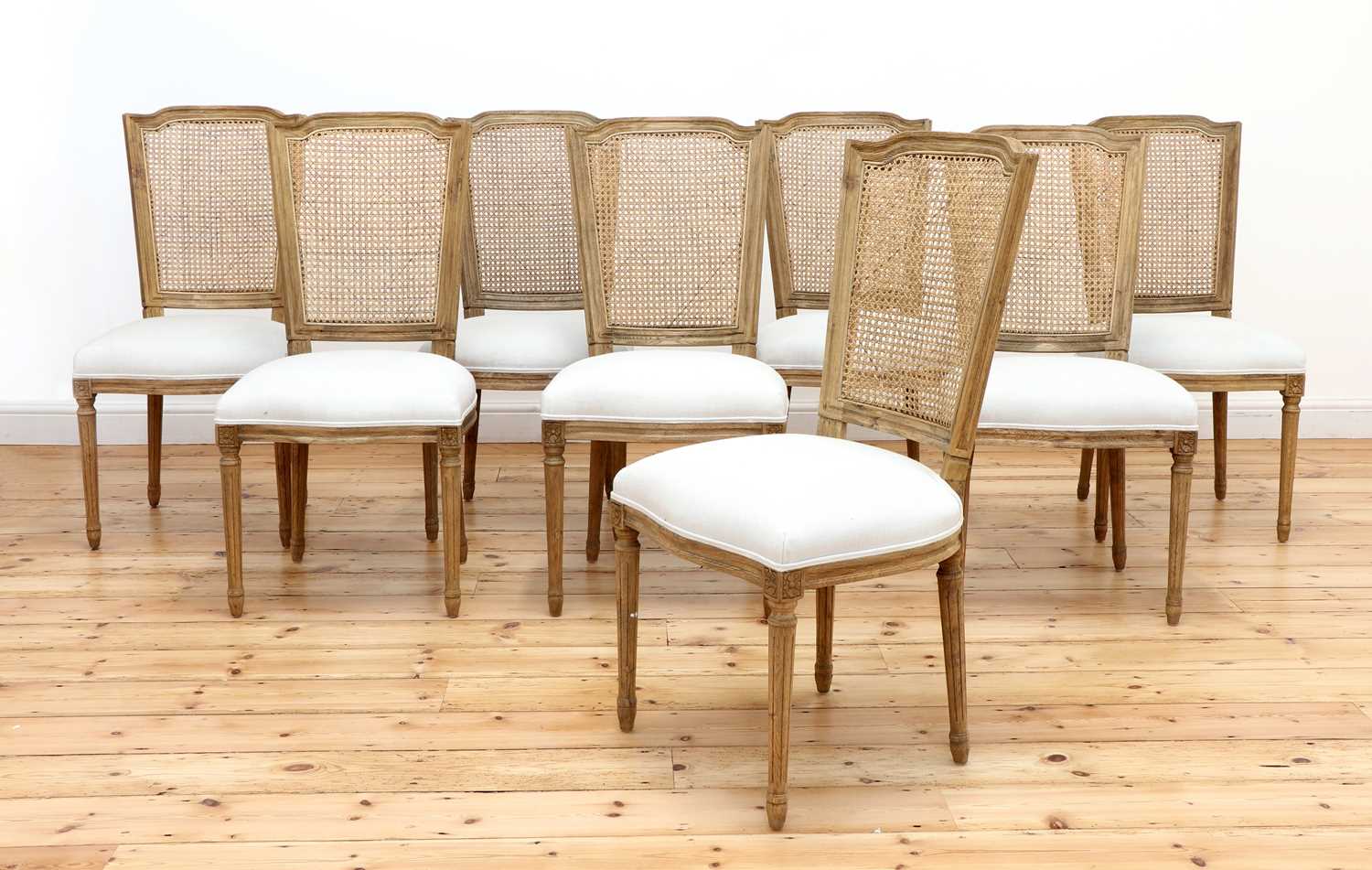 Lot 423 - A set of eight modern bleached oak dining chairs
