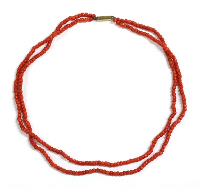 Lot 46 - A two row barrel shaped coral bead necklace