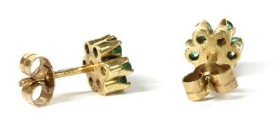 Lot 124 - A pair of gold emerald cluster earrings