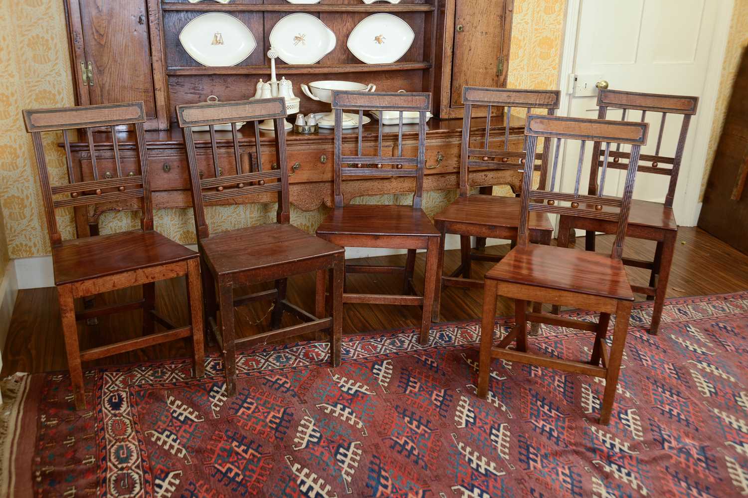 Lot 216 - A set of six George III oak dining chairs