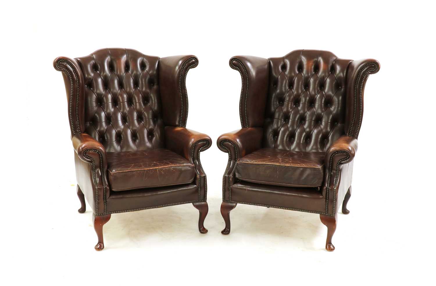 Lot 297 - A pair of Queen Anne-style wingback armchairs