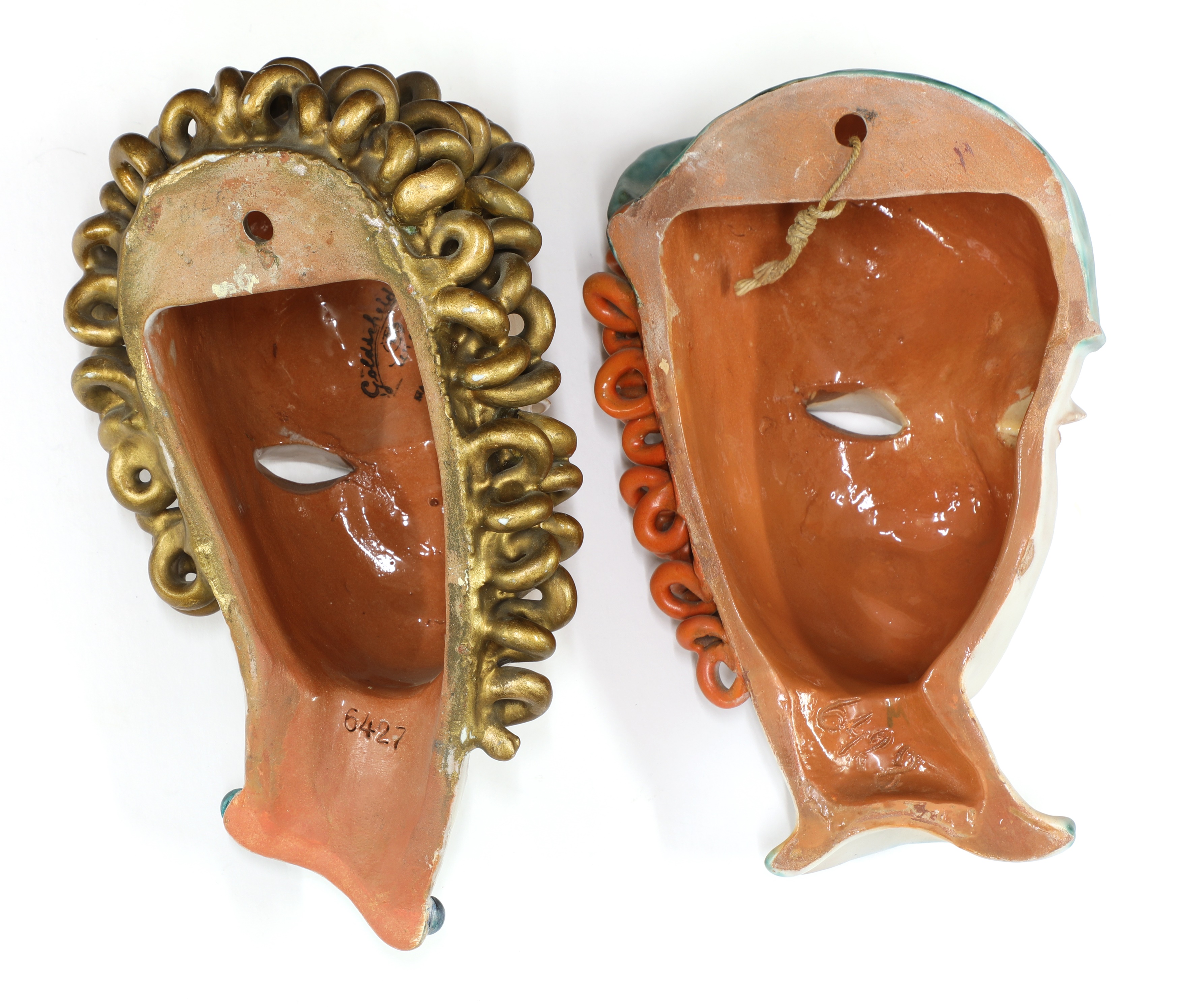 Lot 129 - Two Goldscheider pottery wall masks,