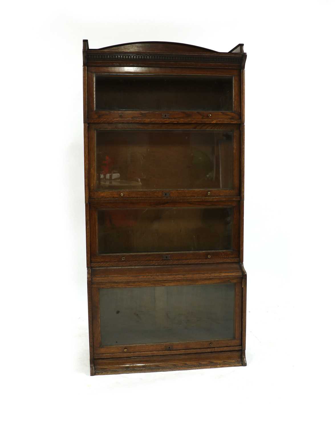 Lot 252 - An oak Lebos four-section bookcase