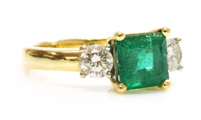 Lot 347 - An 18ct two colour gold three stone emerald and diamond ring
