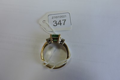 Lot 347 - An 18ct two colour gold three stone emerald and diamond ring