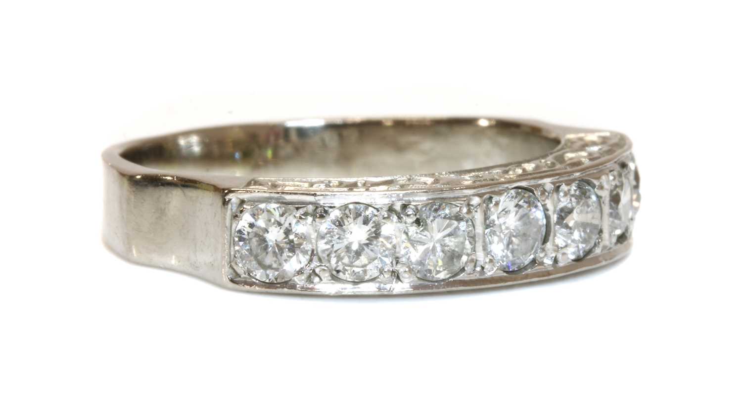 Lot 44 - An 18ct white gold seven stone diamond half eternity ring