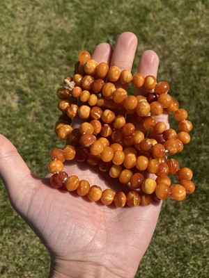 Lot 27 - A single row slightly graduated butterscotch amber prayer bead necklace