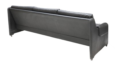 Lot 531 - A black three-seater leather sofa