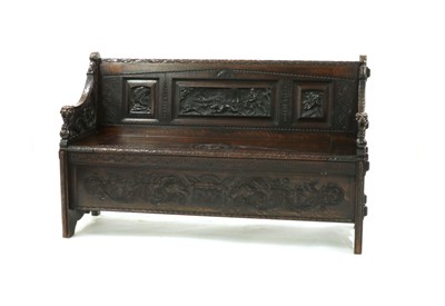 Lot 262 - An Edwards and Roberts profusely carved oak settle