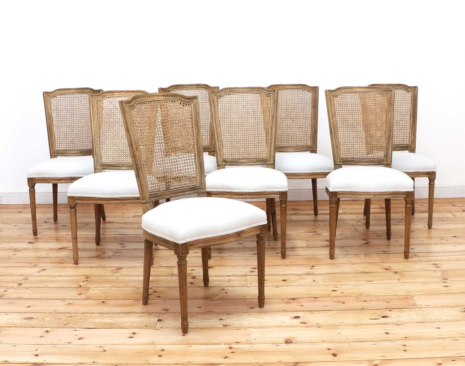 Lot 424 - A set of eight modern bleached oak dining chairs