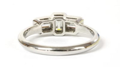 Lot 113 - A platinum three stone emerald cut diamond ring