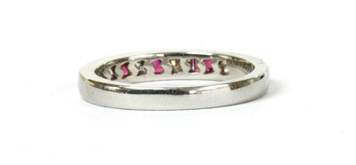 Lot 138 - A platinum ruby and diamond half eternity ring
