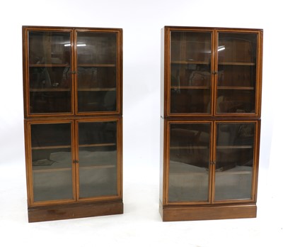 Lot 614 - A pair of two-part inlaid mahogany cabinets