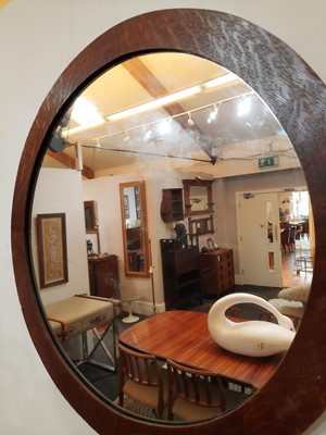 Lot 84 - A pair of Arts and Crafts circular oak wall mirrors