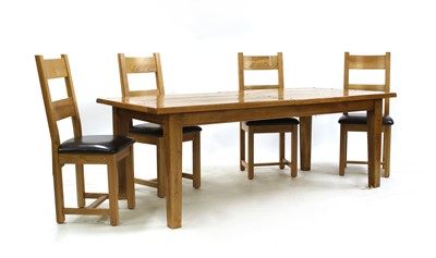 Lot 624 - A modern oak extending dining table and a set of twelve chairs