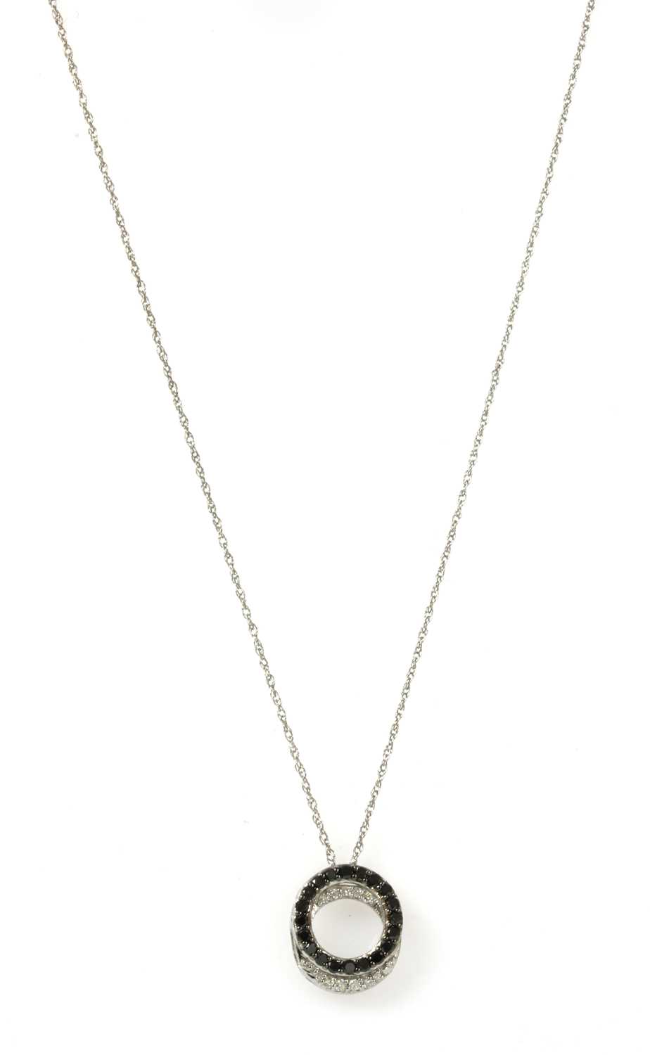 Lot 130 - A white gold black and white diamond pendant