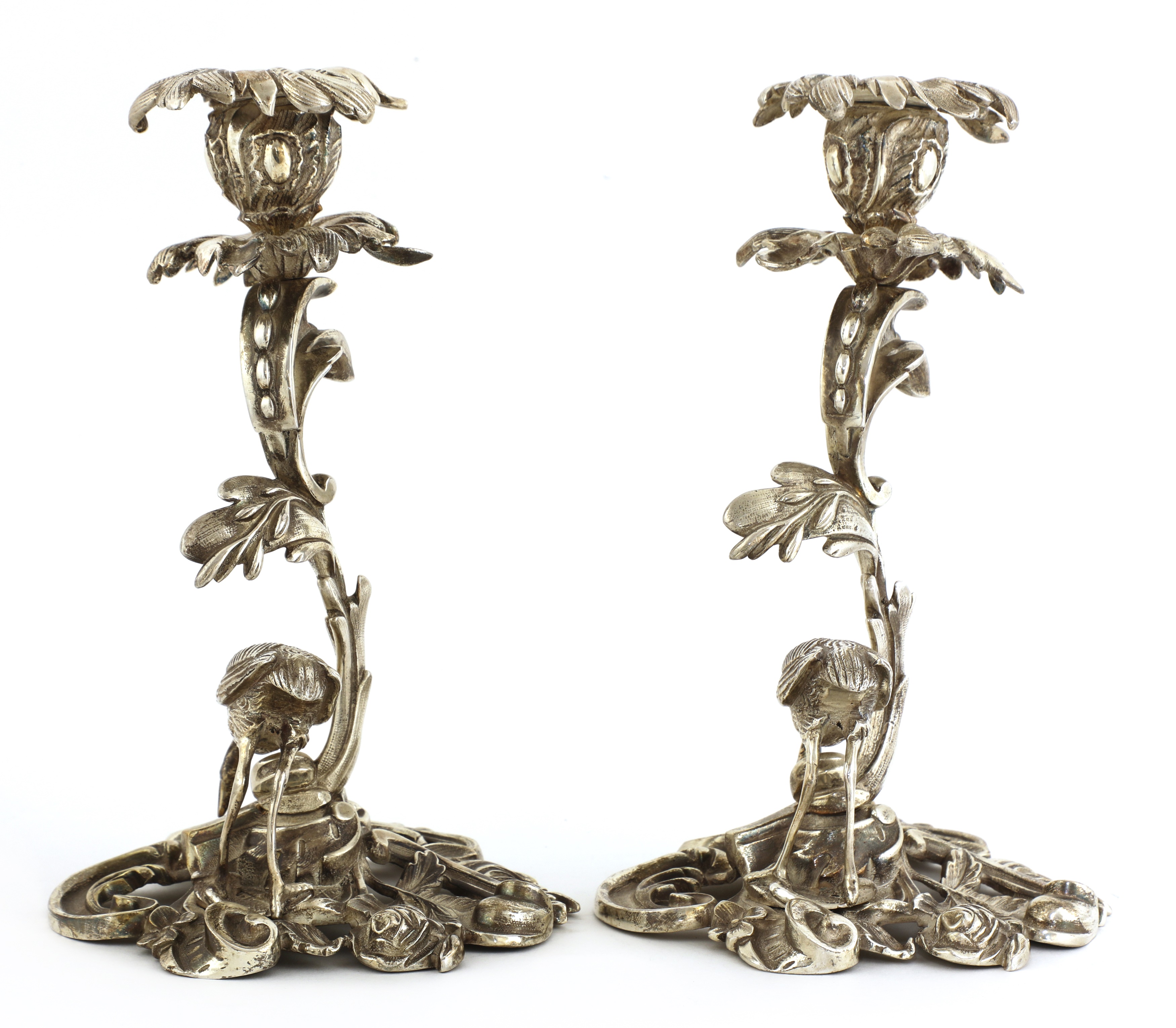 Lot 509 - A pair of cast silver-plated candlesticks,