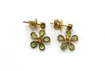 Lot 195 - A pair of silver and gold, peridot and diamond floral cluster earrings
