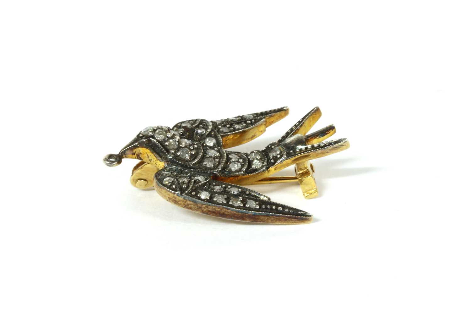 Lot 102 - A silver diamond set swallow brooch