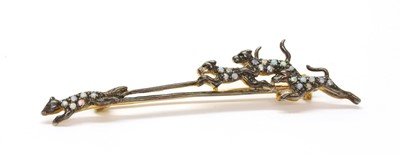 Lot 180 - A silver opal and diamond set hunting scene brooch