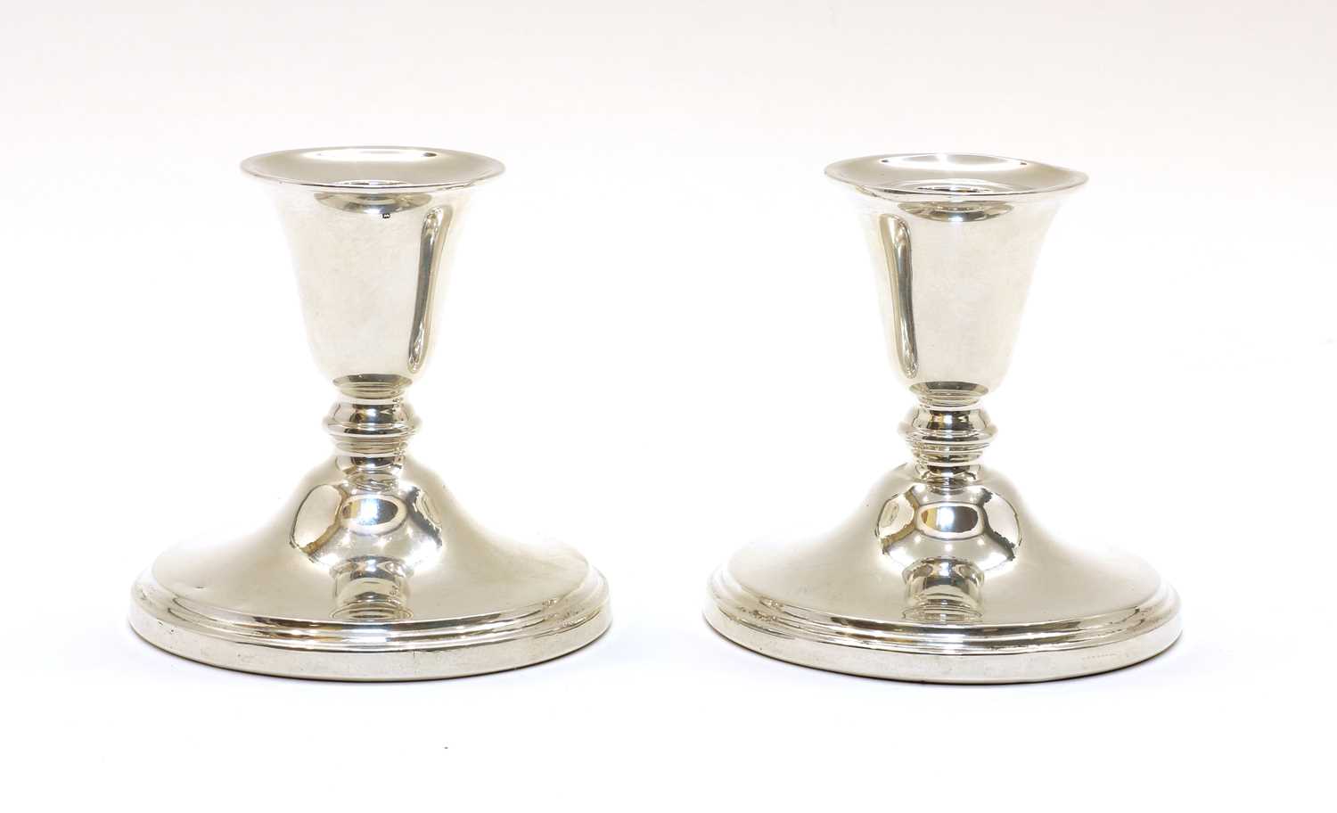 Lot 75 - A pair of silver dwarf candlesticks by Adie & Sons Ltd