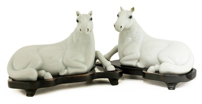 Lot 55 - A pair of Chinese white-glazed horses