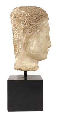 Lot 83 - A carved stone head of Buddha