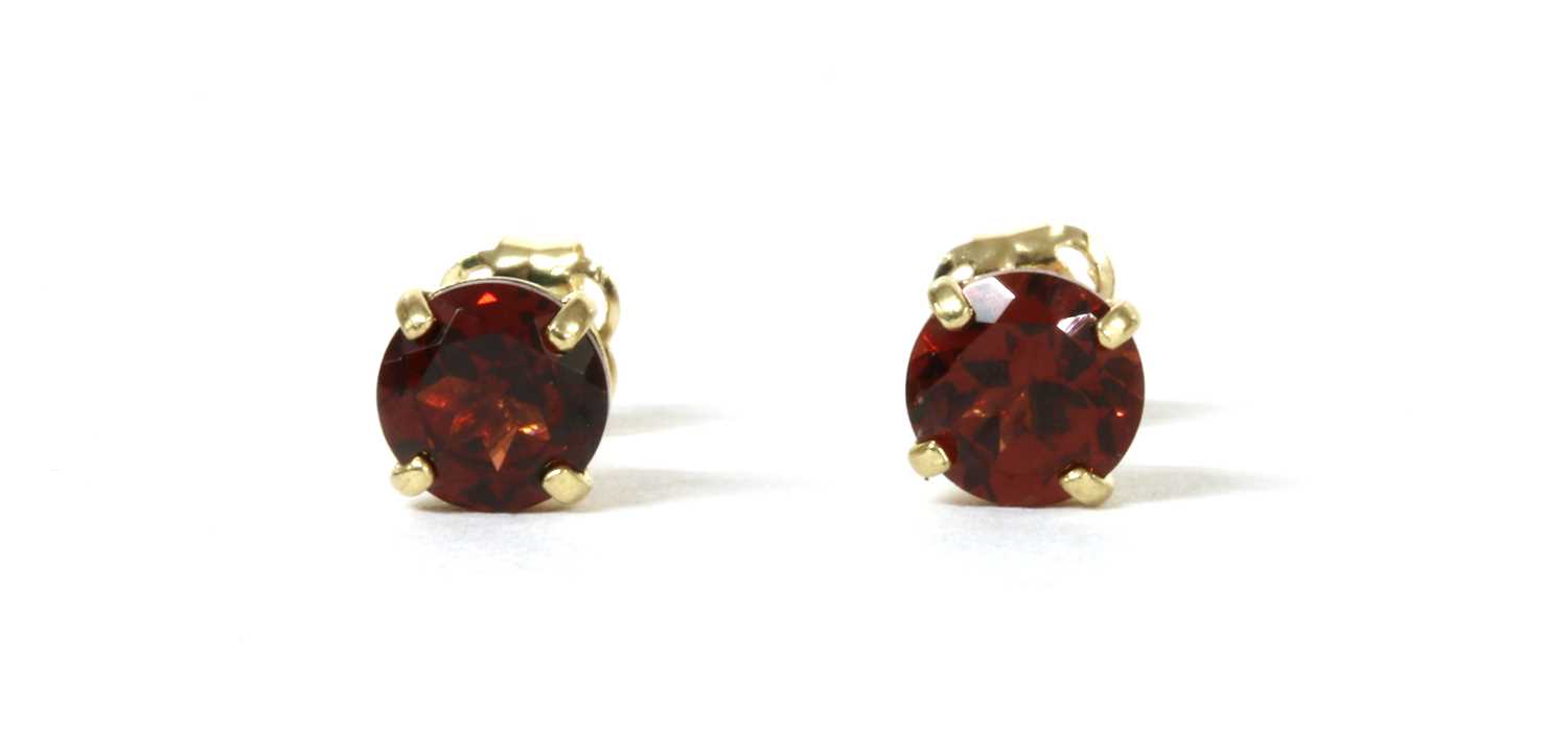 Lot 152 - A pair of gold single stone garnet stud earrings