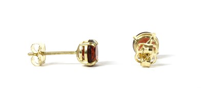 Lot 152 - A pair of gold single stone garnet stud earrings