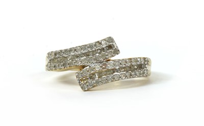 Lot 255 - A silver gilt diamond set crossover ring