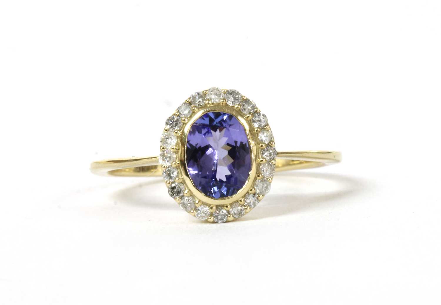 Lot 173 - A gold tanzanite and diamond cluster ring
