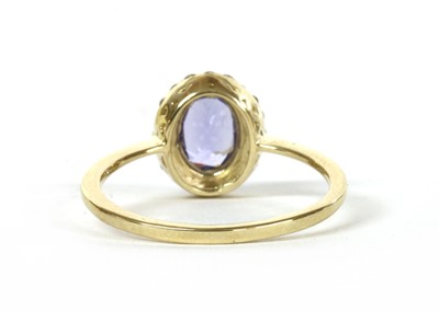 Lot 173 - A gold tanzanite and diamond cluster ring