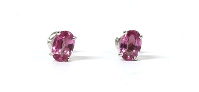 Lot 154 - A pair of white gold single stone pink sapphire stud earrings