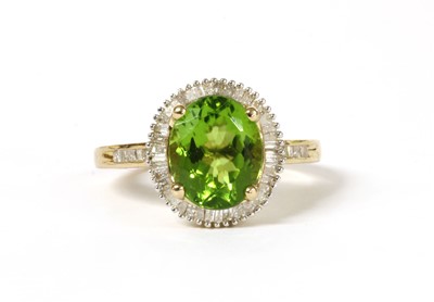 Lot 190 - A gold peridot and diamond cluster ring