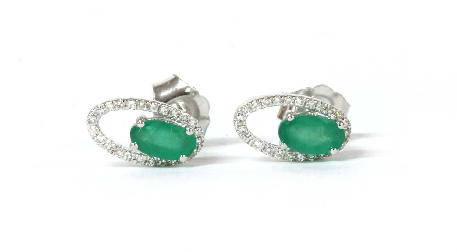 Lot 200 - A pair of white gold emerald and diamond open halo cluster stud earrings