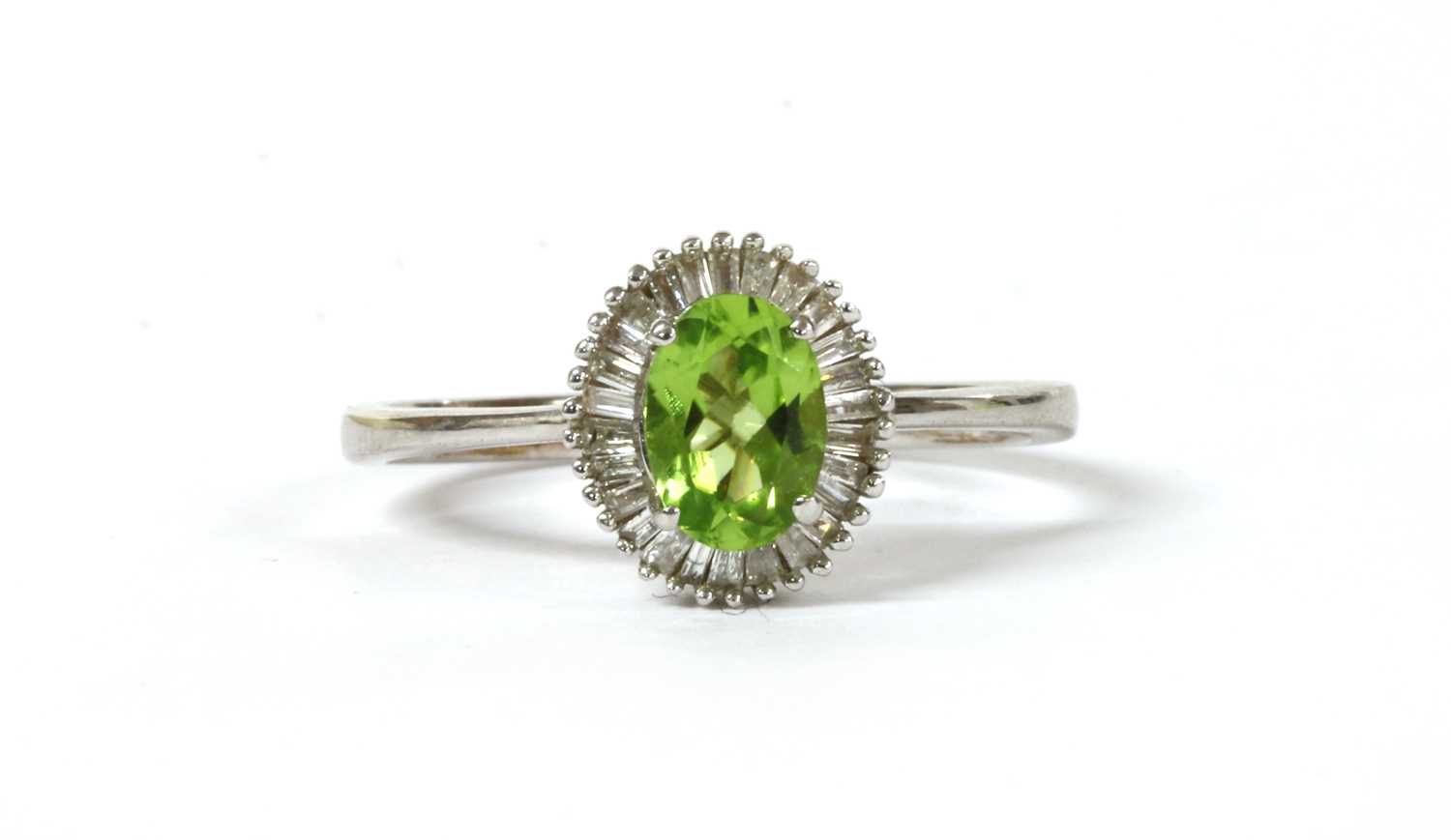 Lot 194 - A white gold peridot and diamond cluster ring
