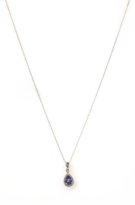 Lot 179 - A white gold tanzanite and diamond cluster pendant