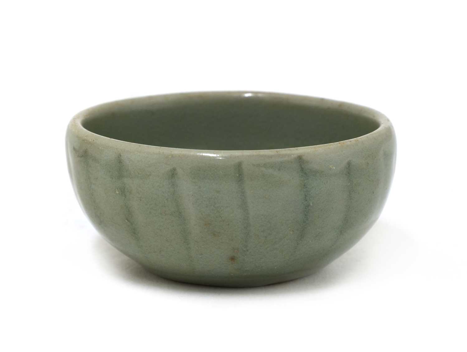 Lot 7 - A Chinese celadon-glazed teacup