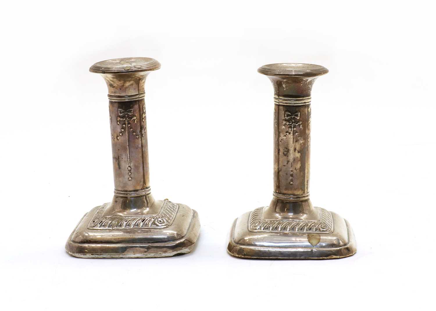 Lot 79 - A pair of  Edwardian weighted silver dwarf candlesticks