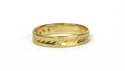 Lot 57 - An 18ct gold flat section patterned wedding ring