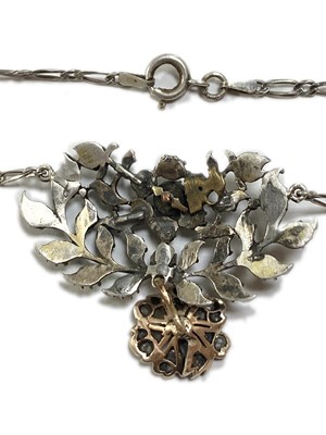 Lot 103 - A silver and gold, diamond set pendant