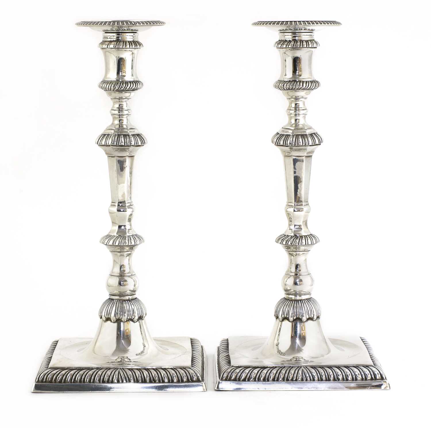 Lot 495 - A pair of cast silver candlesticks