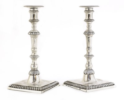 Lot 495 - A pair of cast silver candlesticks