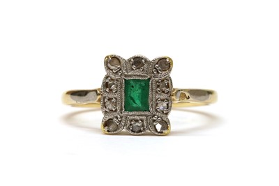 Lot 1265 - An 18ct gold emerald and diamond cluster ring