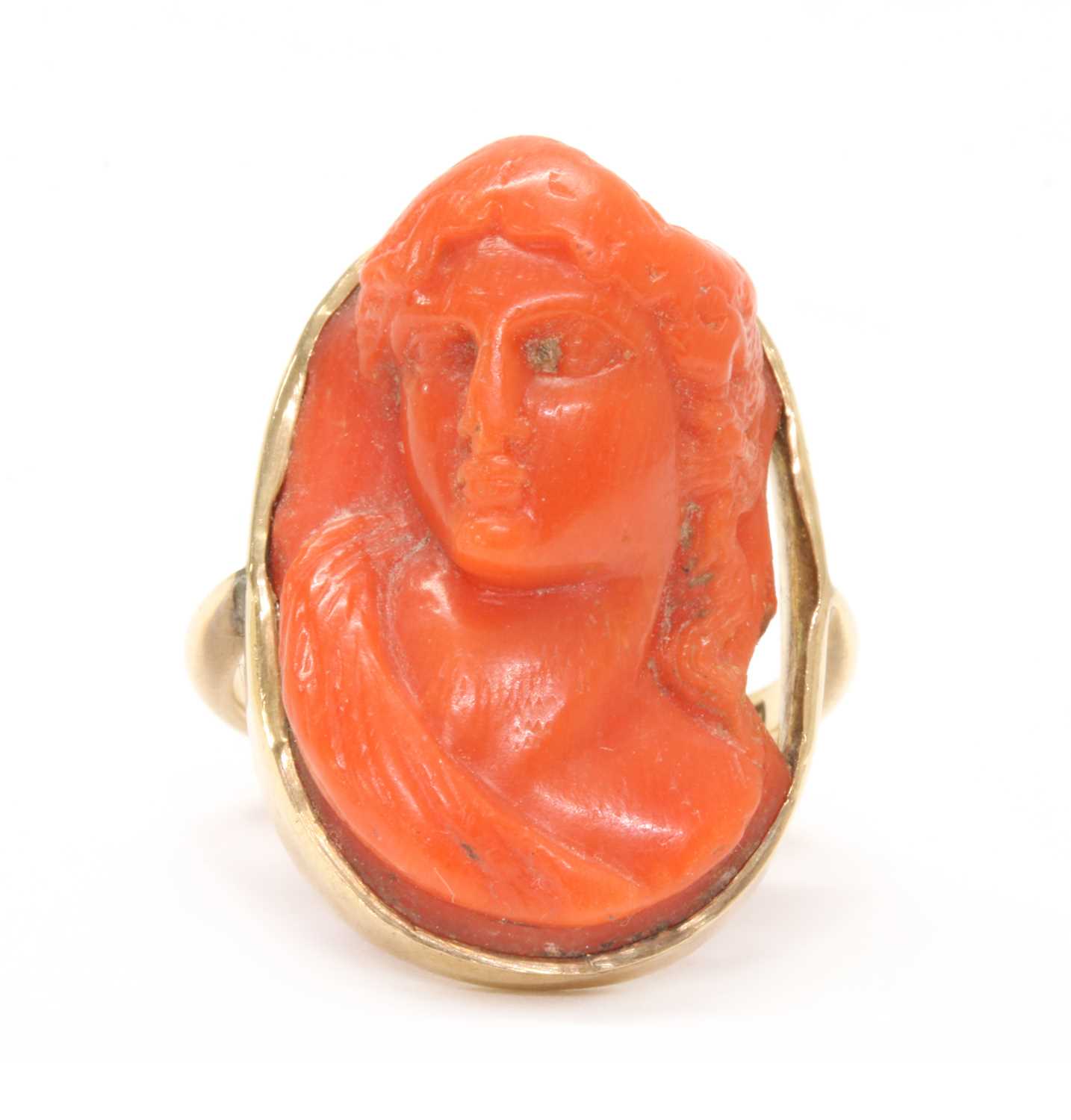 Lot 24 - A gold carved coral cameo ring