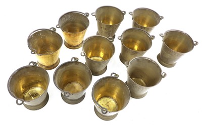 Lot 106 - A set of eleven brass buckets