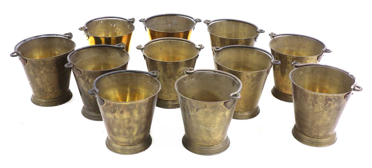 Lot 106 - A set of eleven brass buckets
