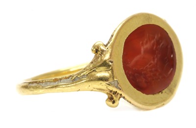 Lot 4 - A gold cornelian intaglio ouroboros ring